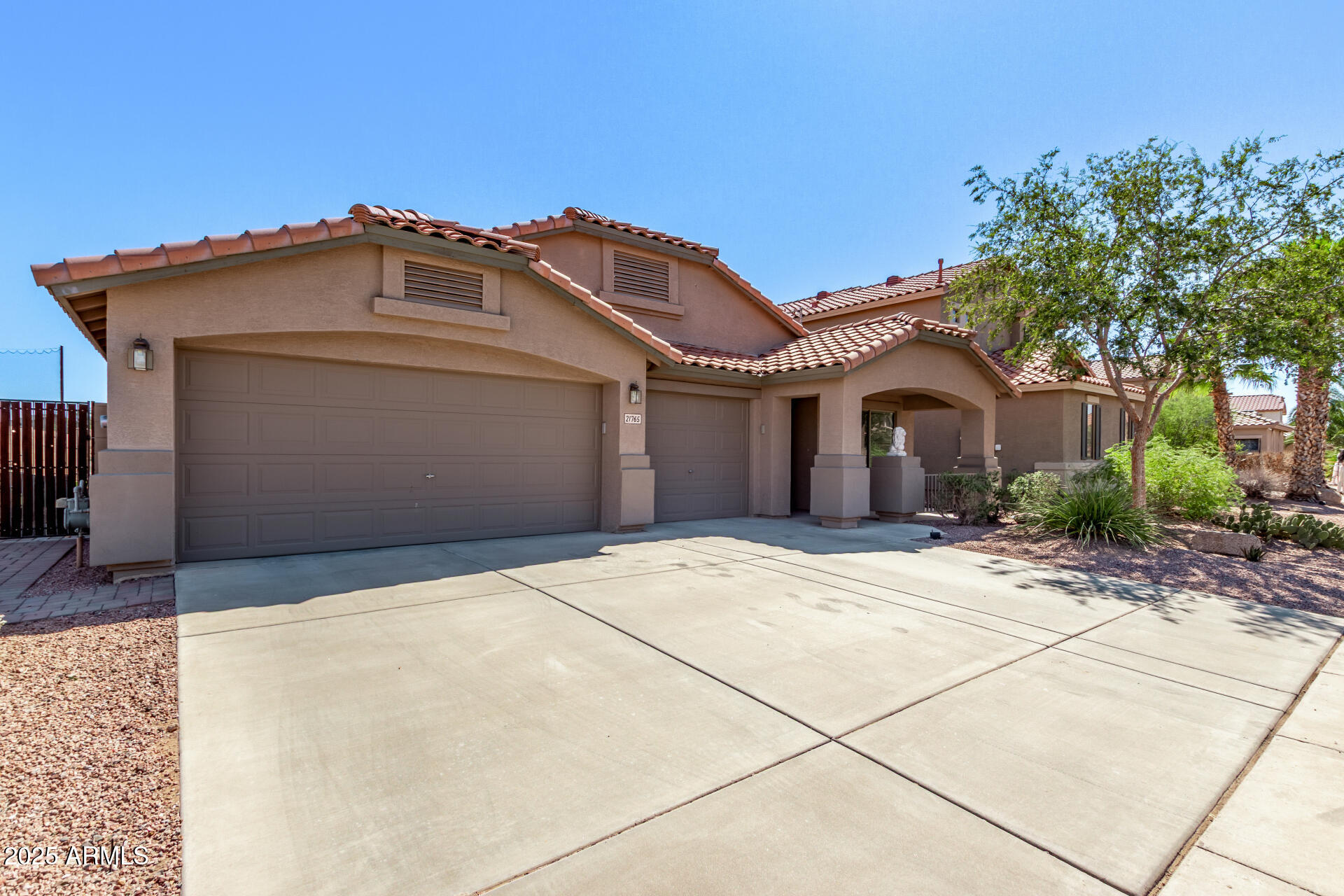 21765 Backus Drive Maricopa, AZ 85138 - Photo 4 of 43 a front view of a house with a yard and garage