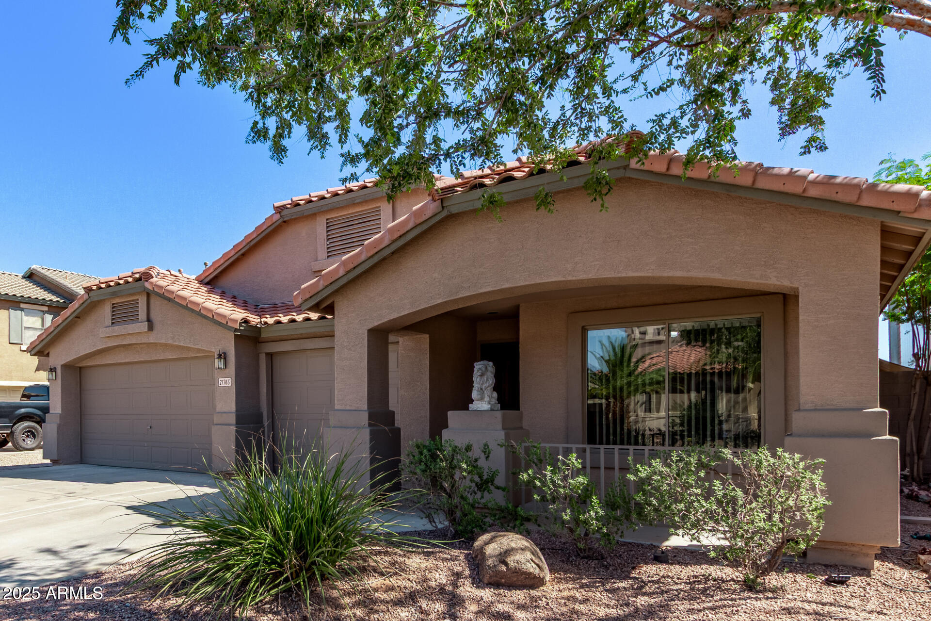 21765 Backus Drive Maricopa, AZ 85138 - Photo 6 of 43 a front view of a house with plants
