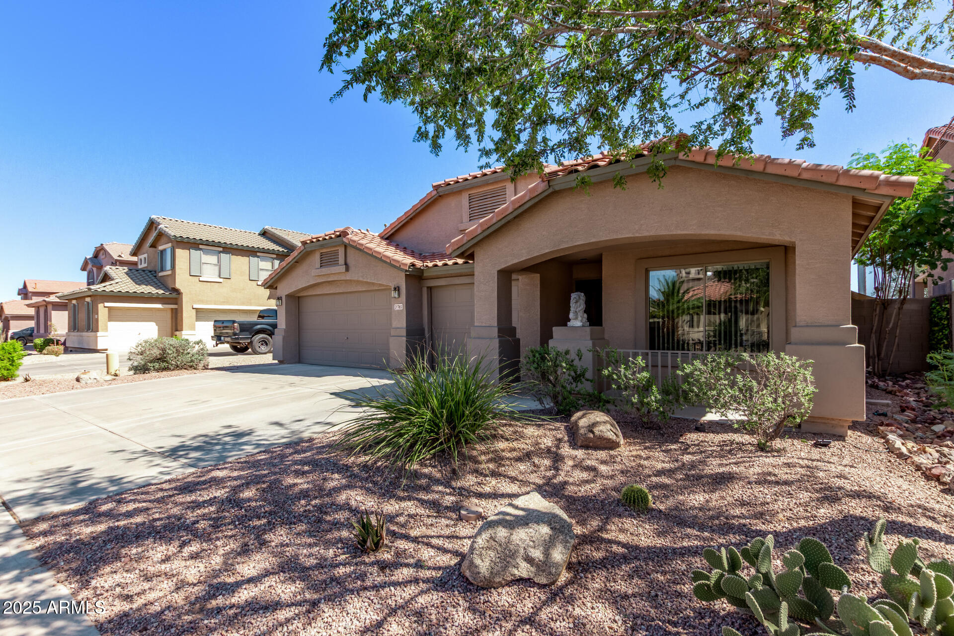 21765 Backus Drive Maricopa, AZ 85138 - Photo 7 of 43 a front view of a house with garden