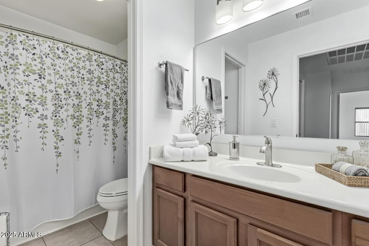 21765 Backus Drive Maricopa, AZ 85138 - Photo 10 of 43 a bathroom with a sink toilet and shower