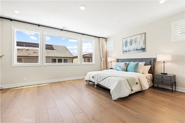 a spacious bedroom with a large bed and a window