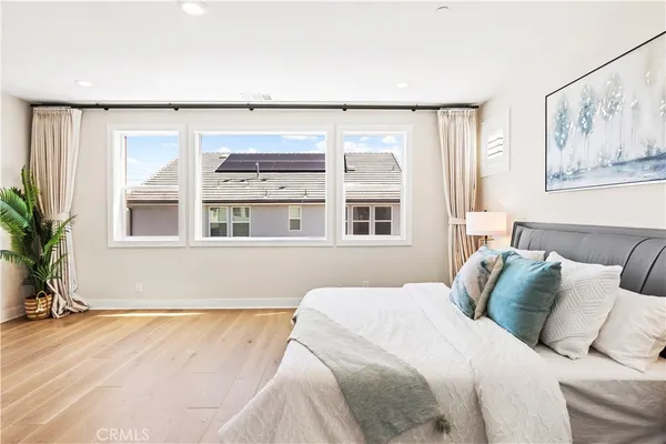 a bedroom with a large bed and a large window