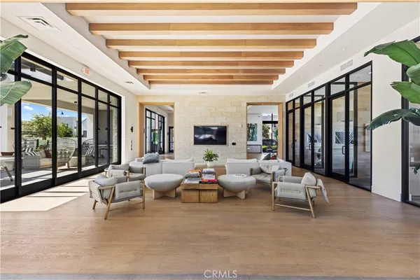 a living room with furniture and large windows
