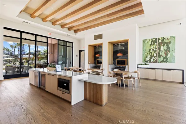a large white kitchen with a large window and furniture