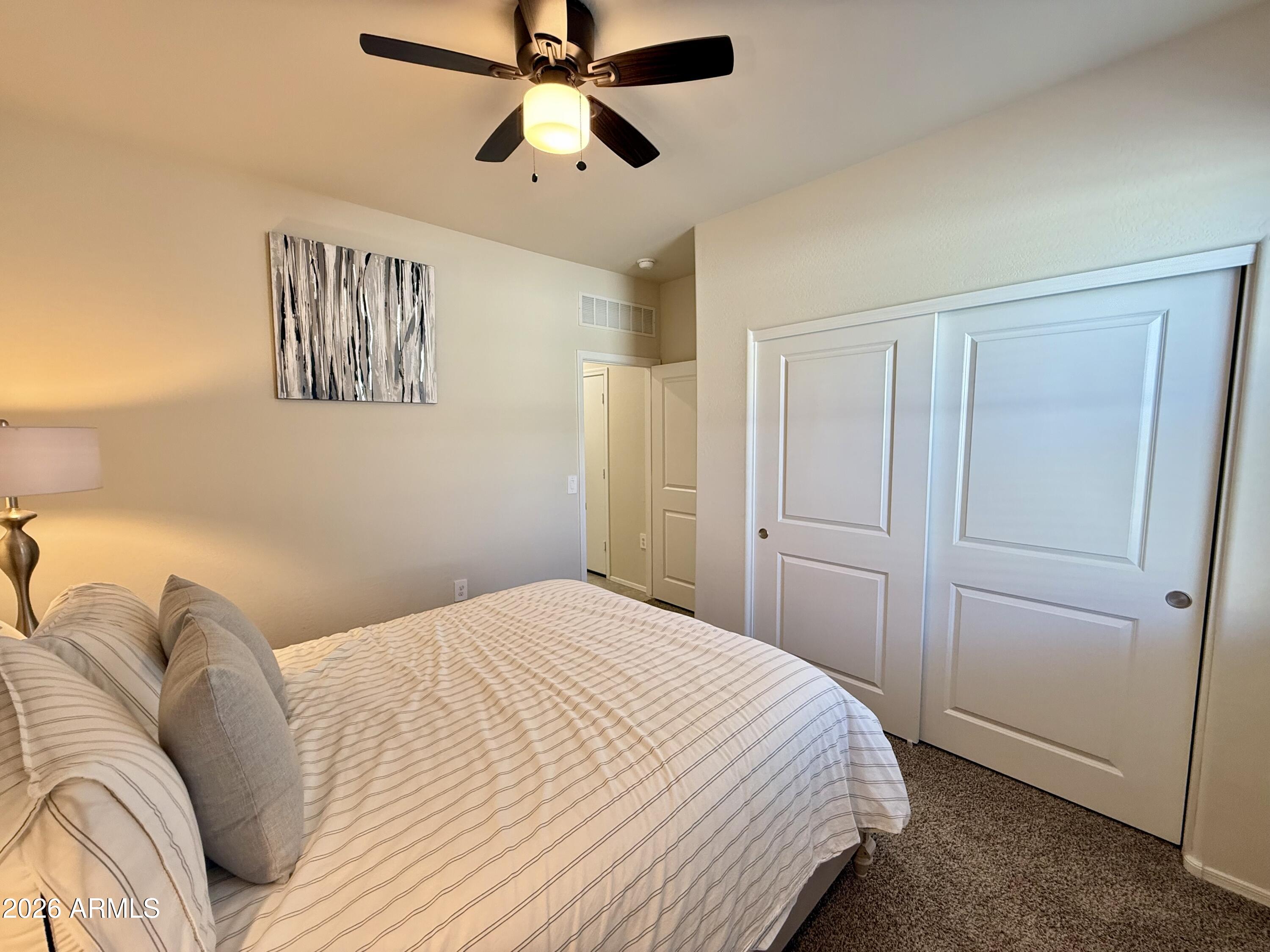 2207 South 46th Street Coolidge, AZ 85128 - Photo 20 of 35 a bedroom with a bed and a chandelier