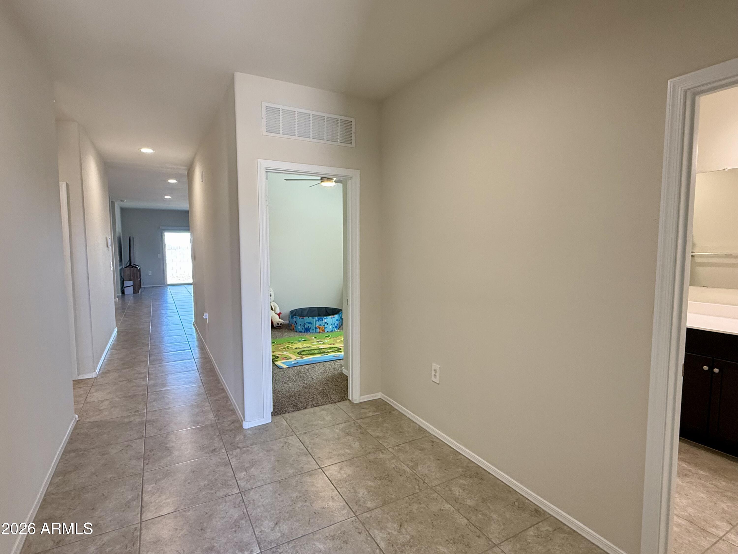 2207 South 46th Street Coolidge, AZ 85128 - Photo 21 of 35 a view of a hallway with wooden floor and a living room