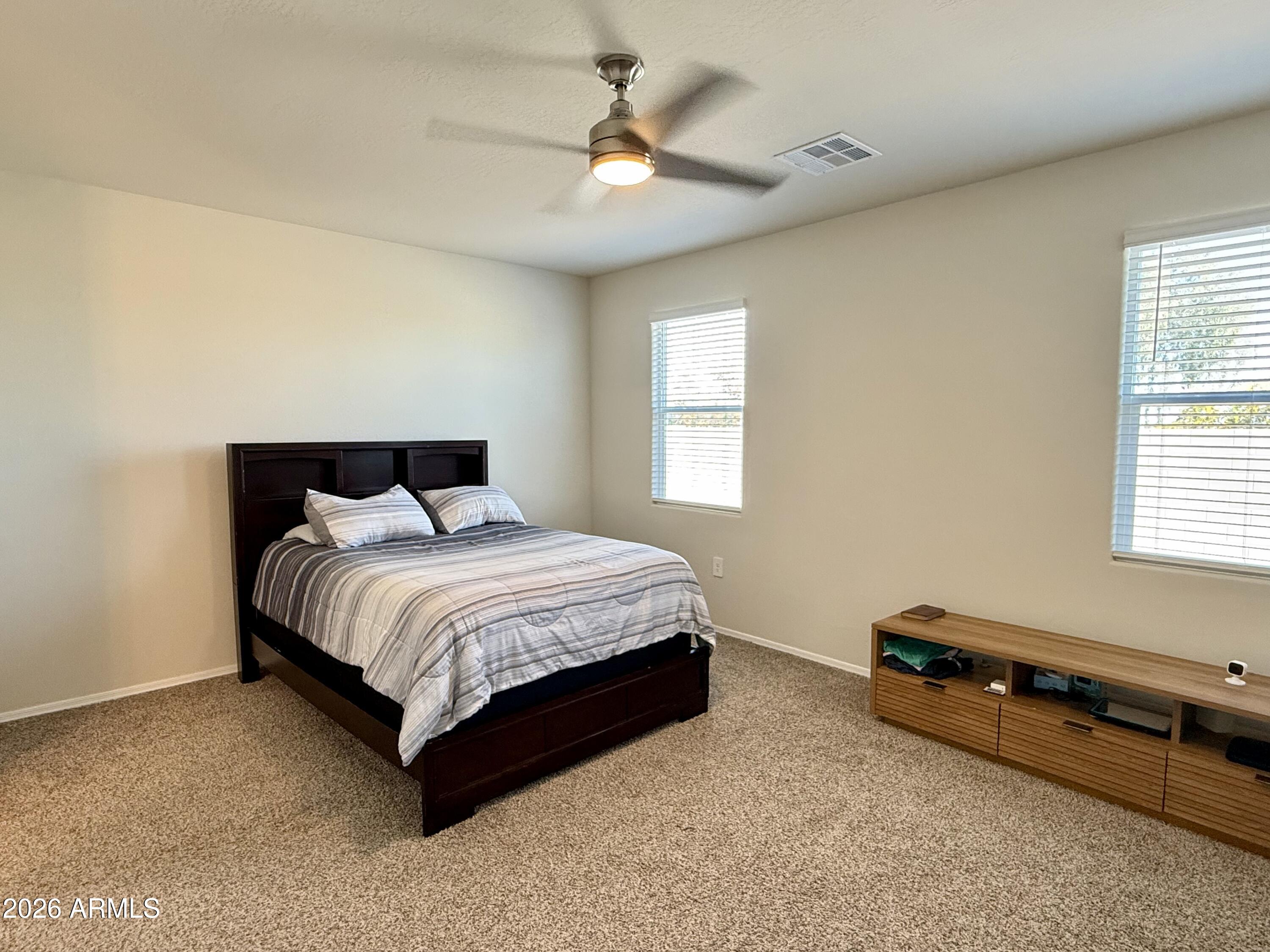 2207 South 46th Street Coolidge, AZ 85128 - Photo 23 of 35 a bedroom with a bed and a chandelier fan