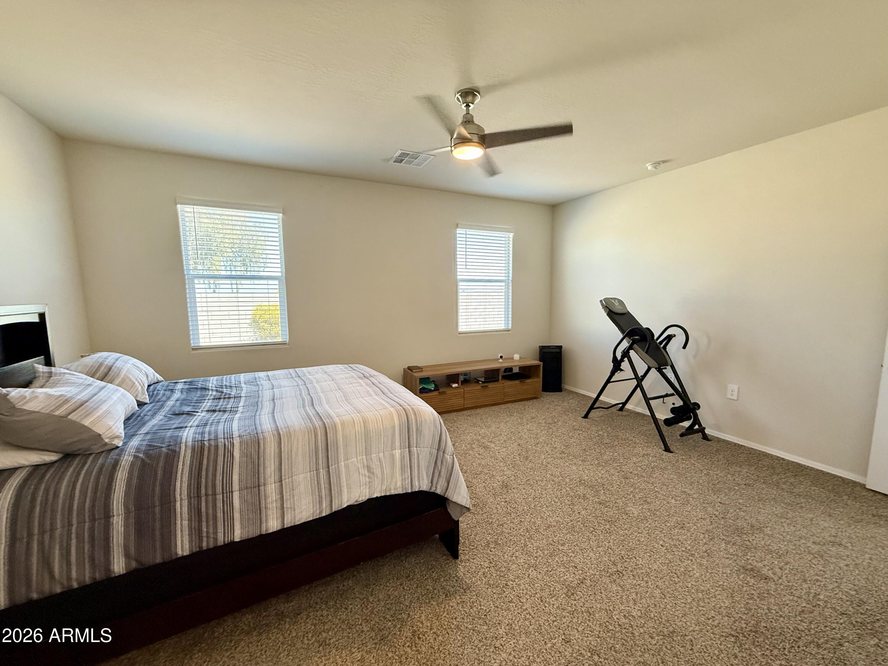2207 South 46th Street Coolidge, AZ 85128 - Photo 24 of 35 a bedroom with a bed and a chandelier