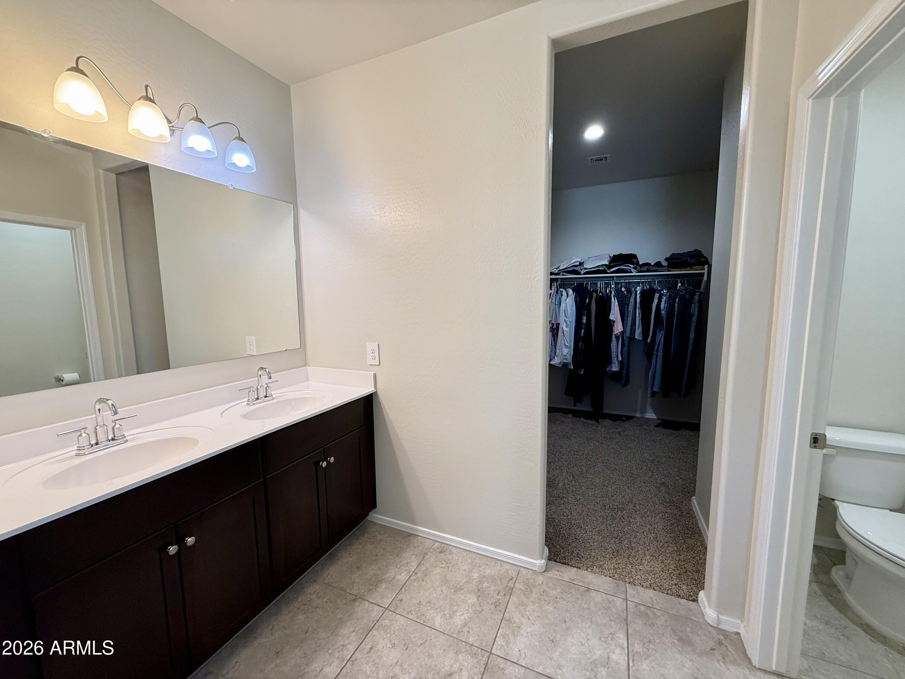 2207 South 46th Street Coolidge, AZ 85128 - Photo 25 of 35 a en suite bathroom with a sink and a mirror