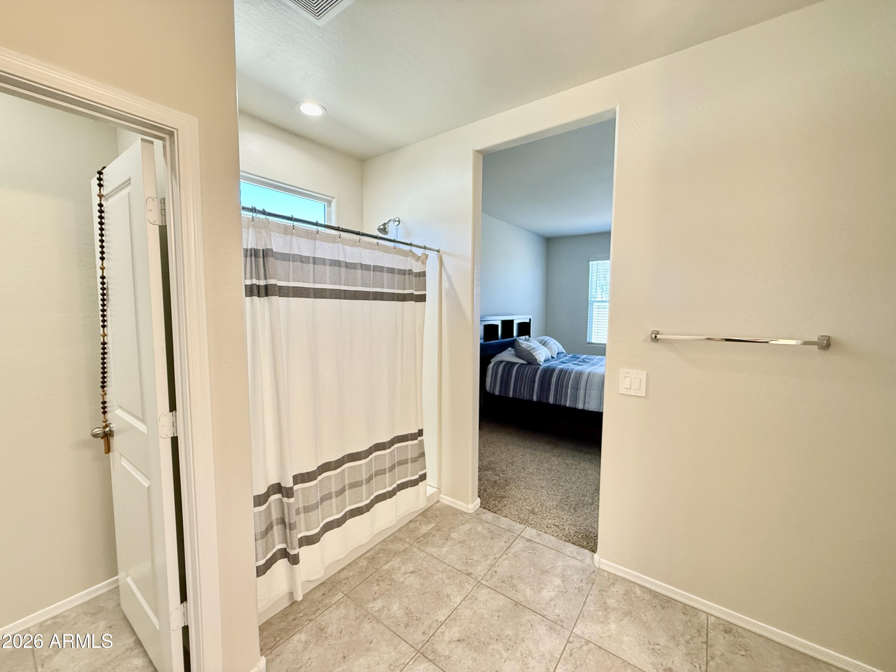 2207 South 46th Street Coolidge, AZ 85128 - Photo 27 of 35 a view of walk in closet with clothes and shoes