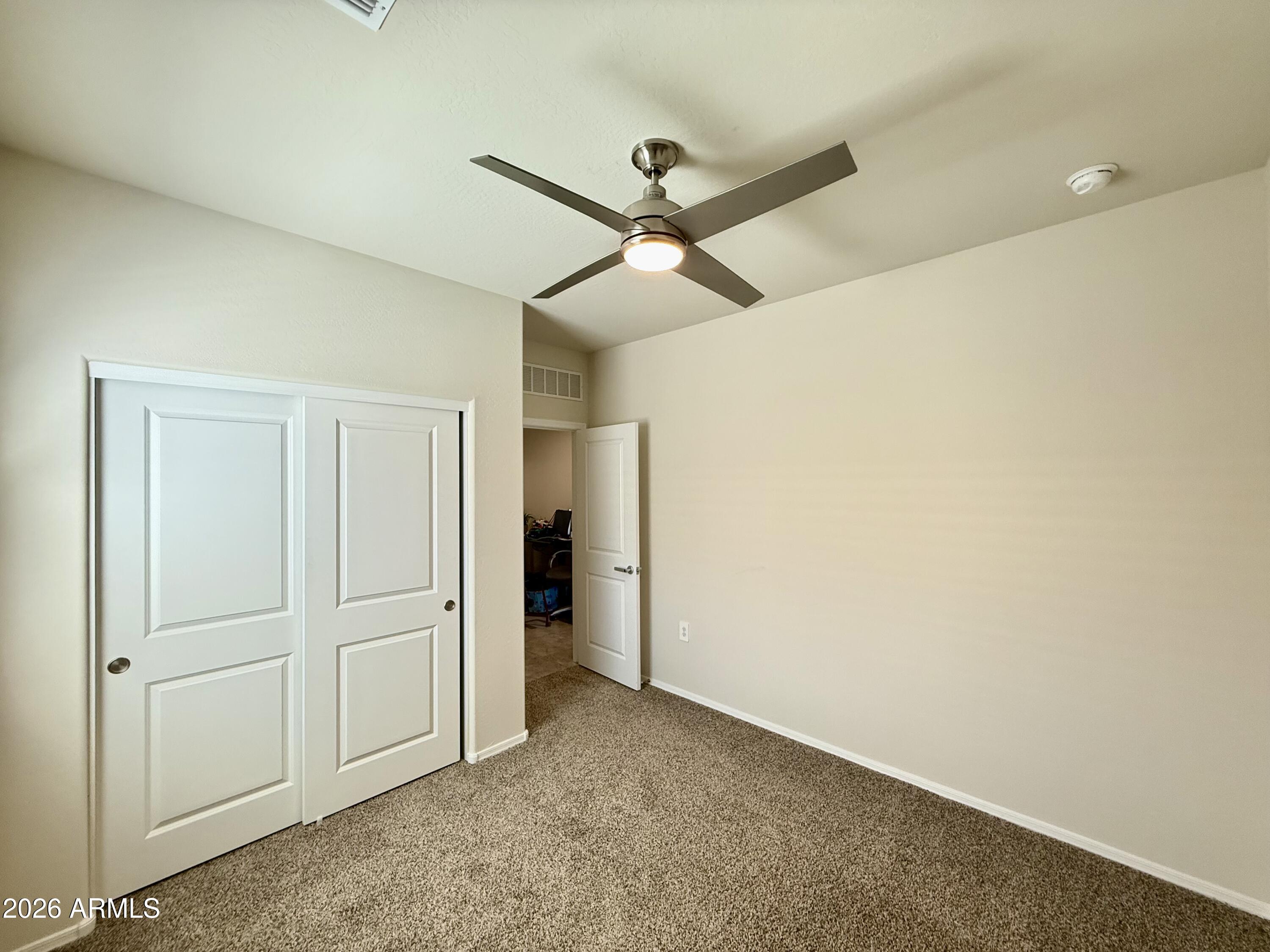 2207 South 46th Street Coolidge, AZ 85128 - Photo 5 of 35 an empty room with closet and fan
