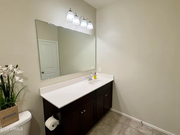 a bathroom with a sink vanity and a mirror