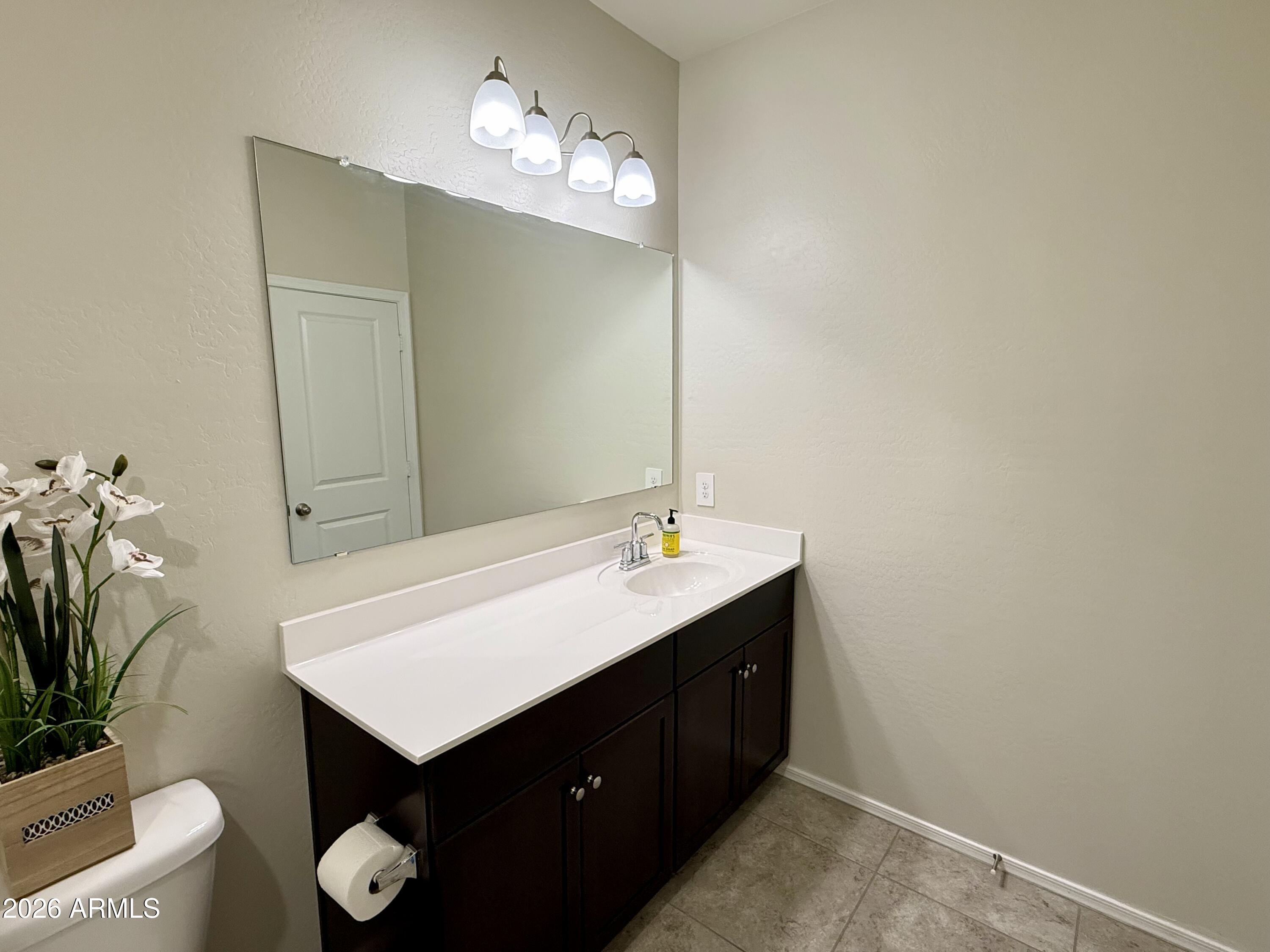 2207 South 46th Street Coolidge, AZ 85128 - Photo 7 of 35 a bathroom with a sink vanity and a mirror
