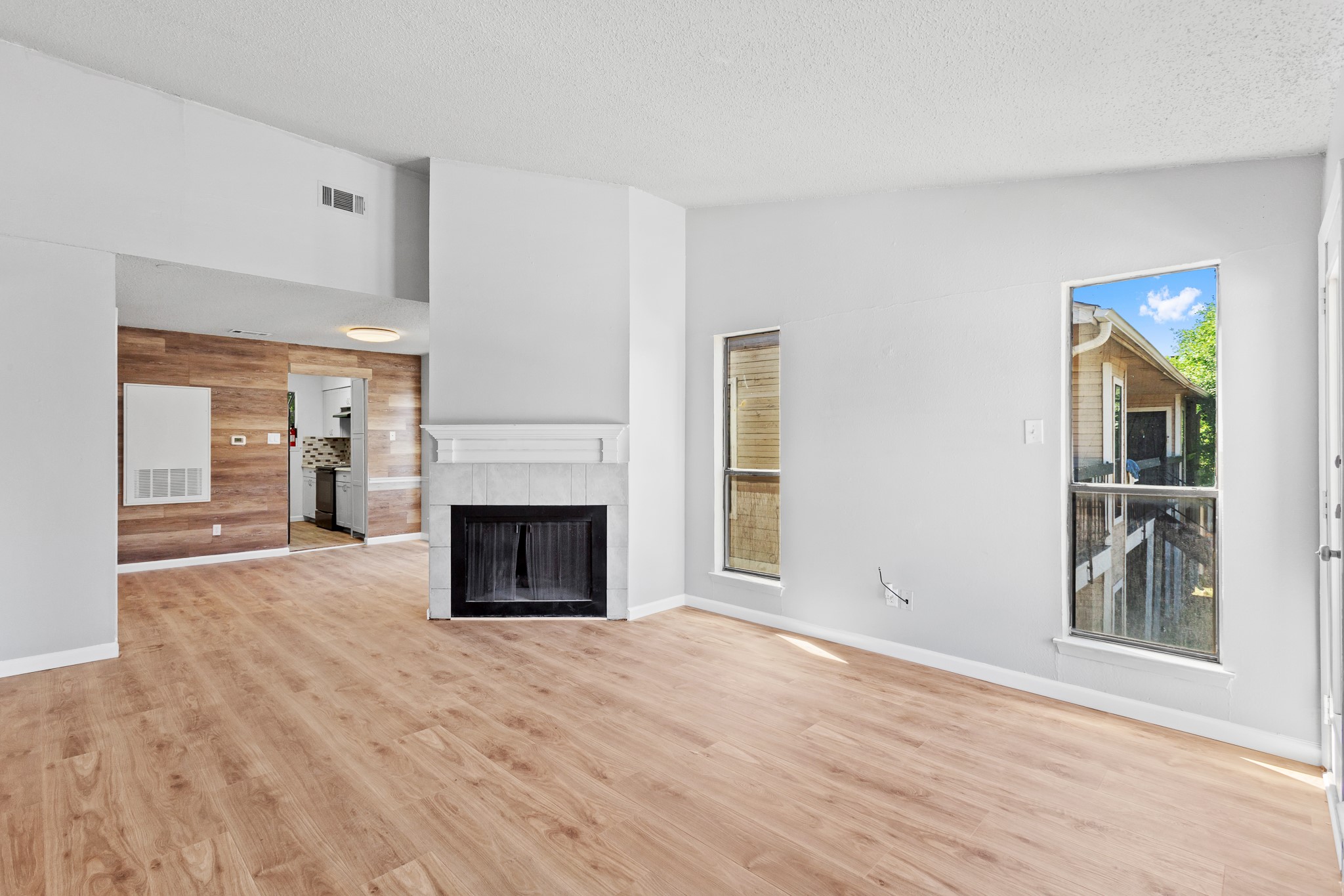 a view of a livingroom with a fireplace and window