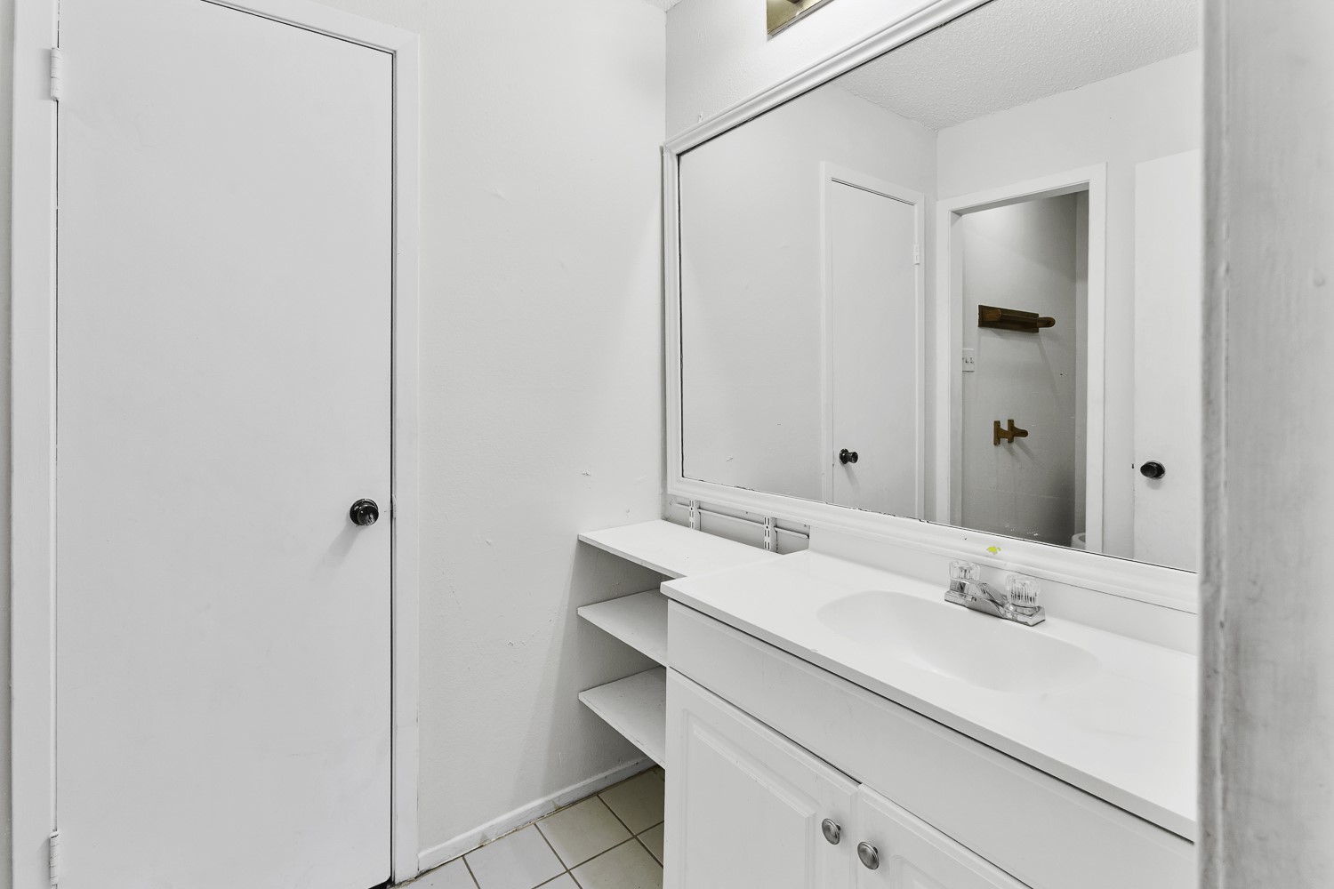 1907 West Loop Austin, TX 78758 - Photo 12 of 22 a bathroom with a sink and a mirror