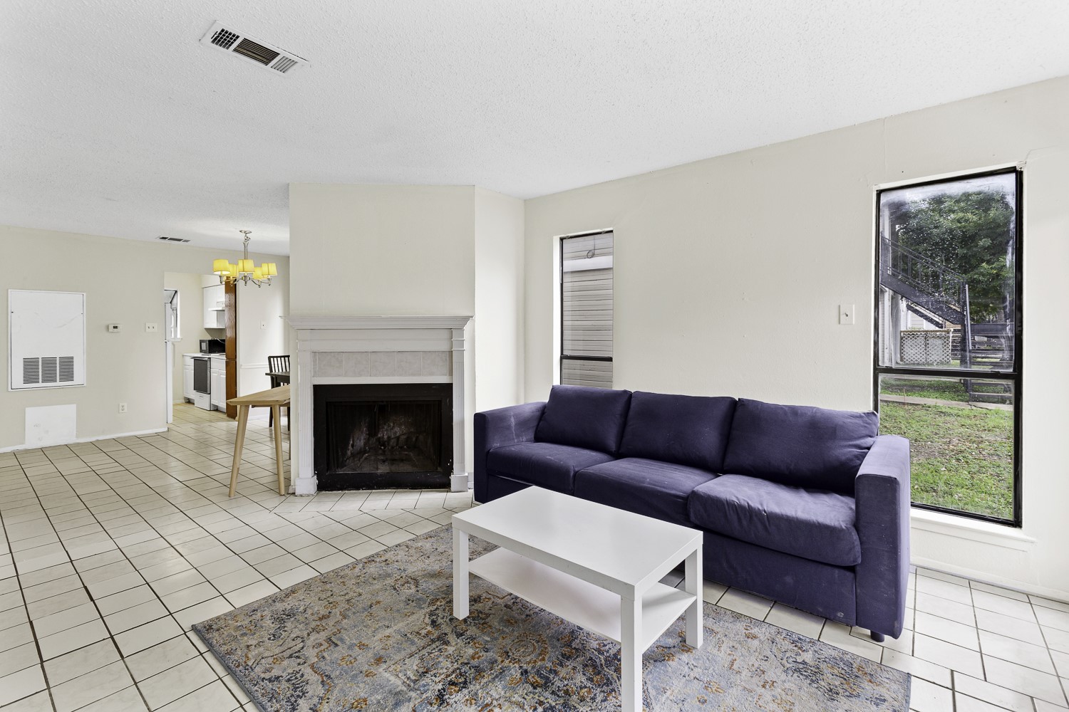 1907 West Loop Austin, TX 78758 - Photo 12 of 31 a living room with furniture and a fireplace