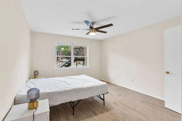a view of a livingroom with wooden floor and a fireplace