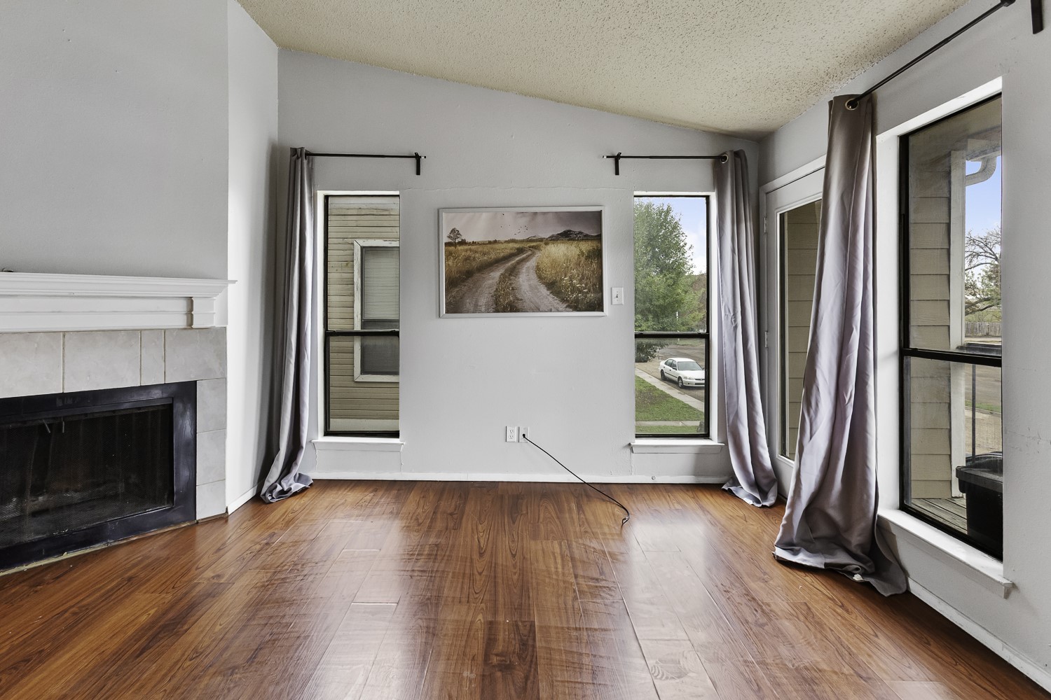 1907 West Loop Austin, TX 78758 - Photo 2 of 22 a view of a livingroom with wooden floor and a fireplace