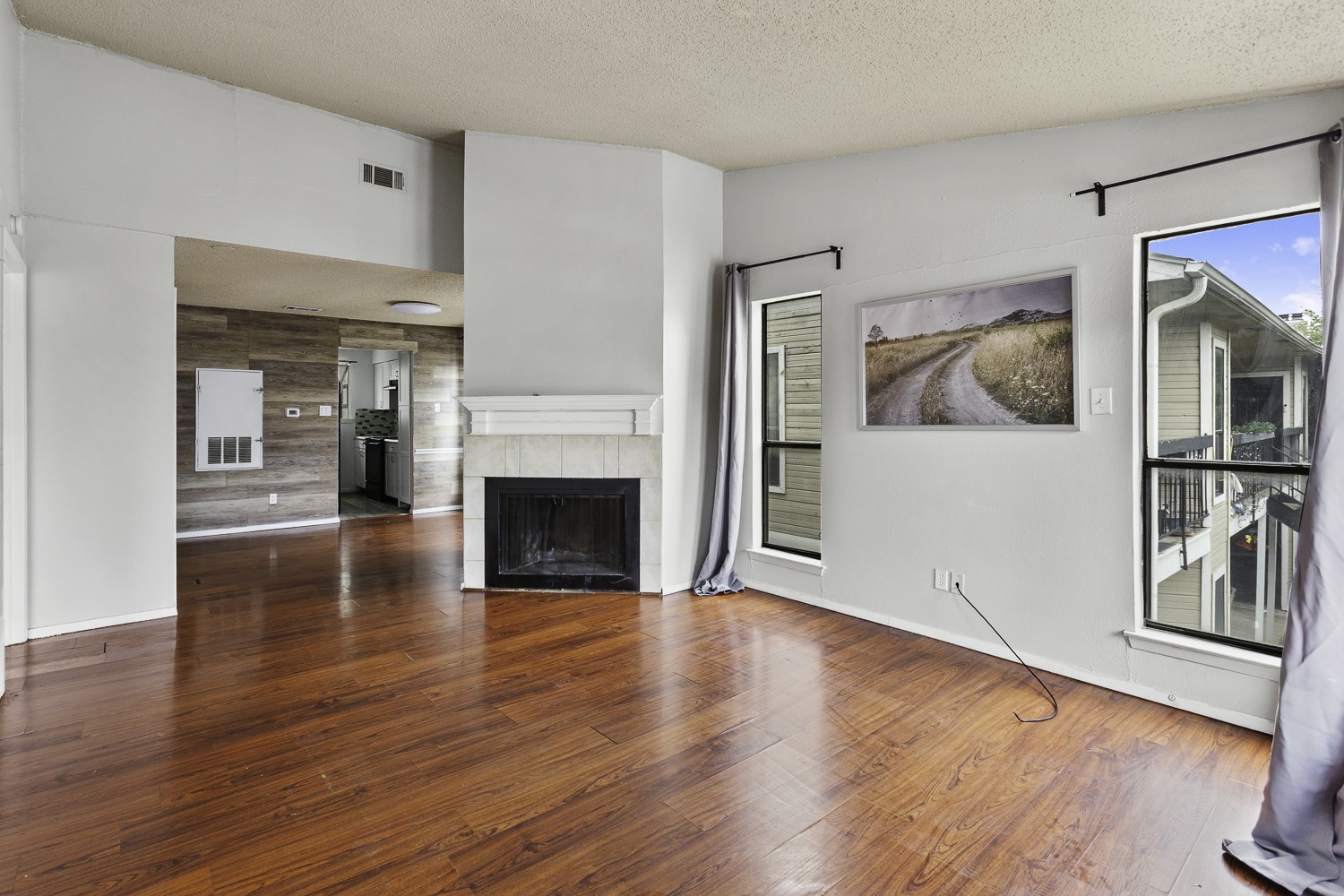 1907 West Loop Austin, TX 78758 - Photo 23 of 31 a view of a livingroom with wooden floor and a fireplace