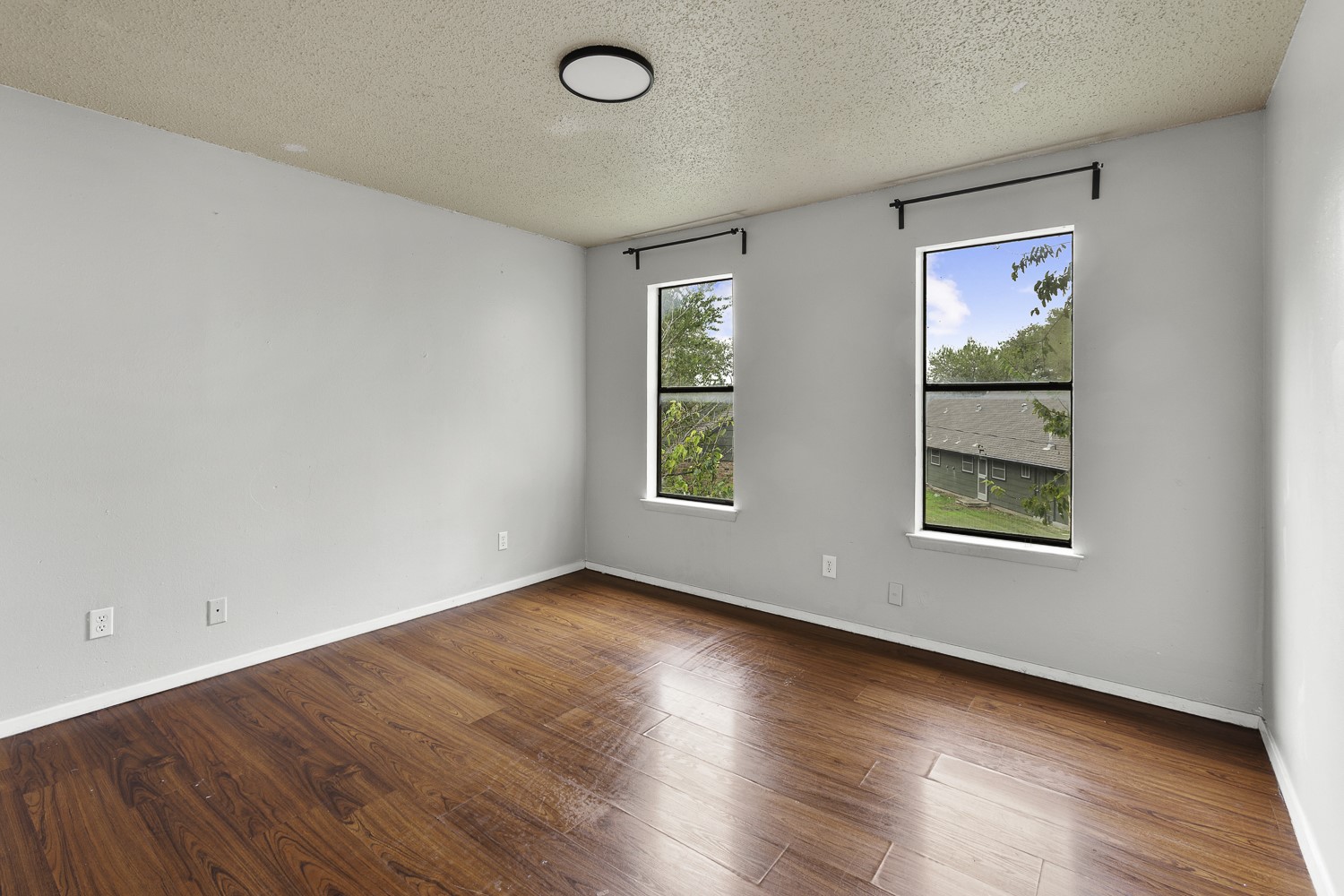 1907 West Loop Austin, TX 78758 - Photo 26 of 31 an empty room with wooden floor and windows