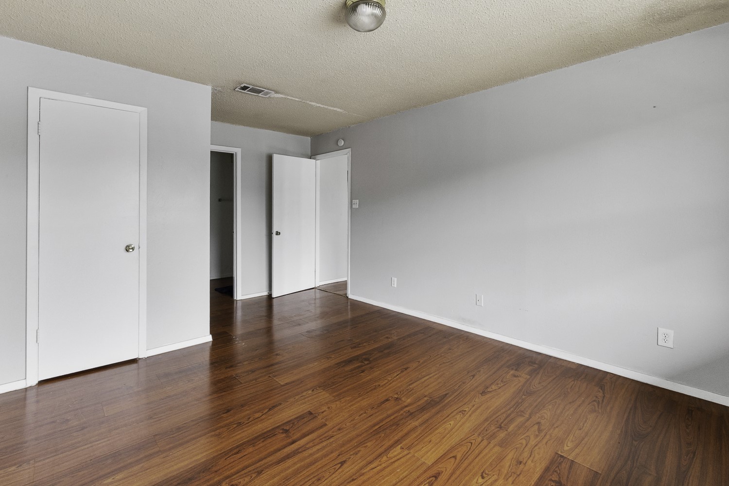 1907 West Loop Austin, TX 78758 - Photo 29 of 31 a view of an empty room with wooden floor and windows