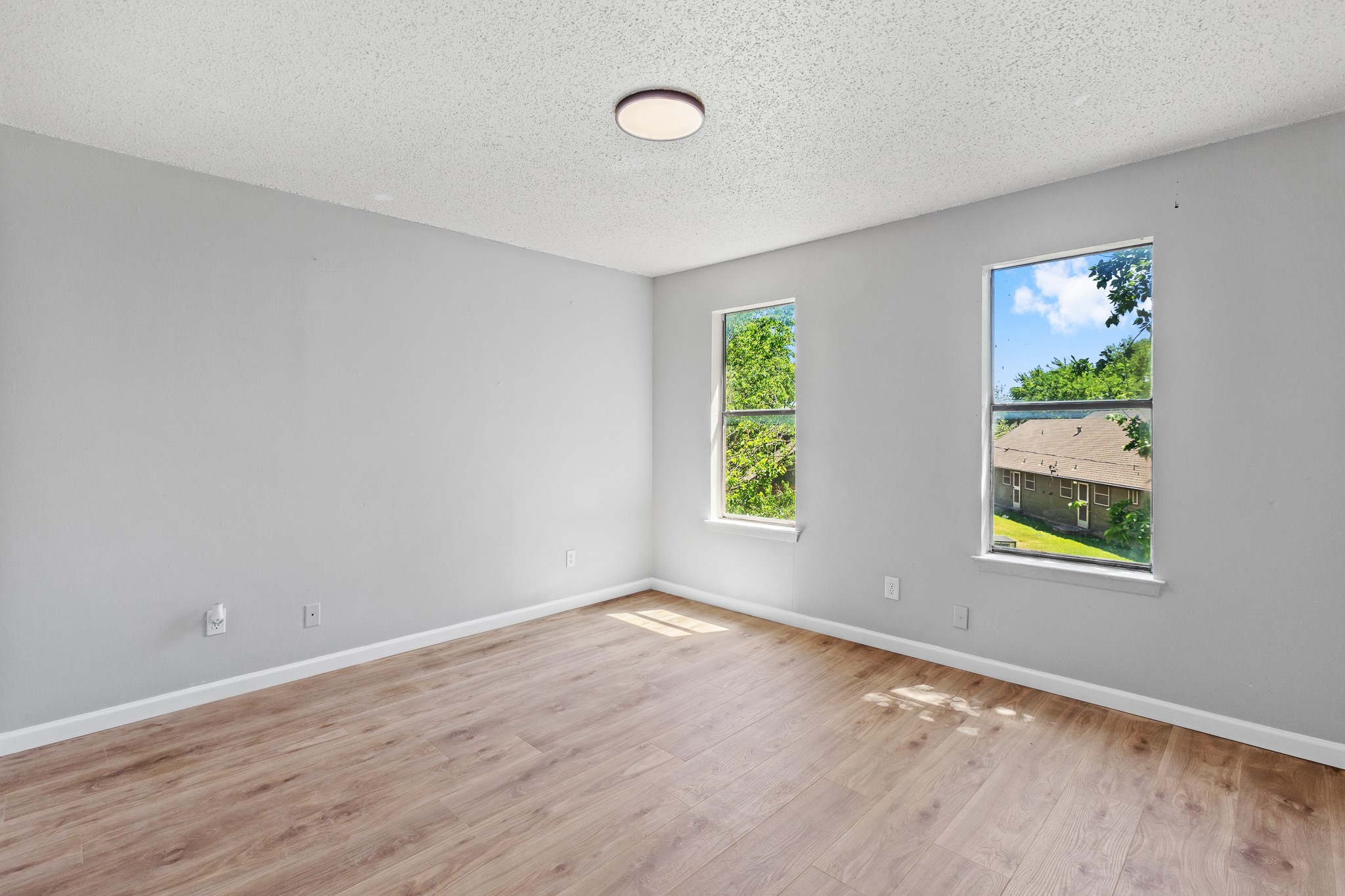 1907 West Loop Austin, TX 78758 - Photo 3 of 31 a view of an empty room with window and wooden floor