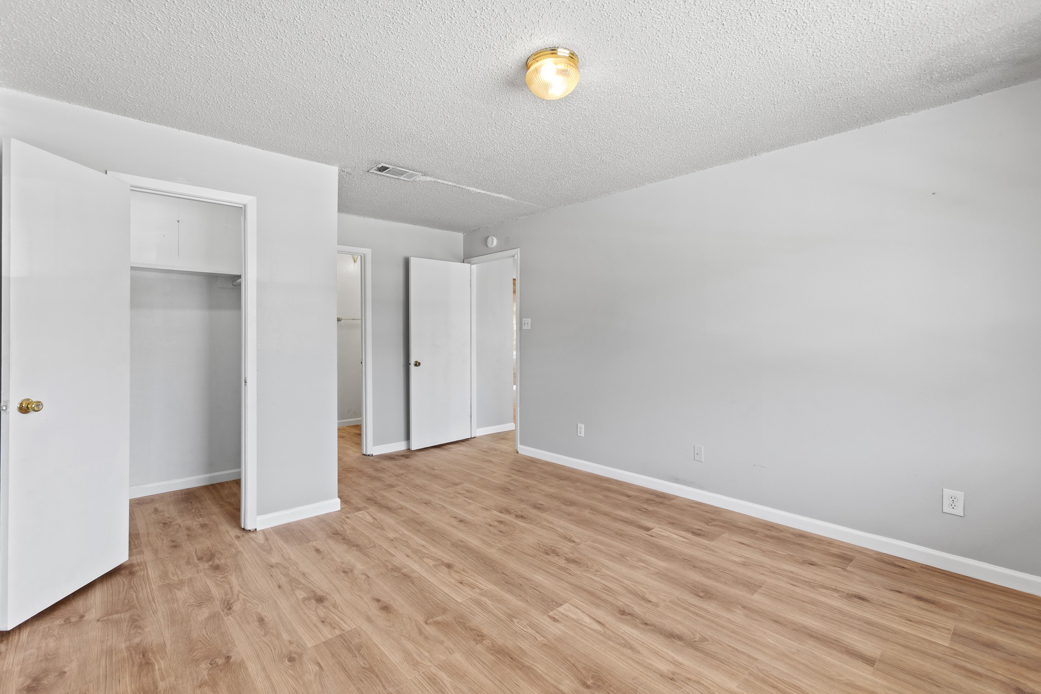1907 West Loop Austin, TX 78758 - Photo 4 of 31 a view of an empty room with wooden floor and a window