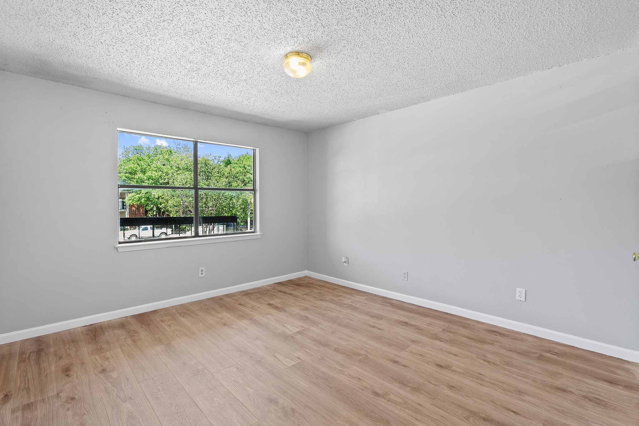 1907 West Loop Austin, TX 78758 - Photo 6 of 31 an empty room with wooden floor and windows
