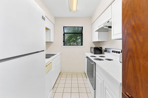 a kitchen with stainless steel appliances granite countertop a refrigerator and a stove