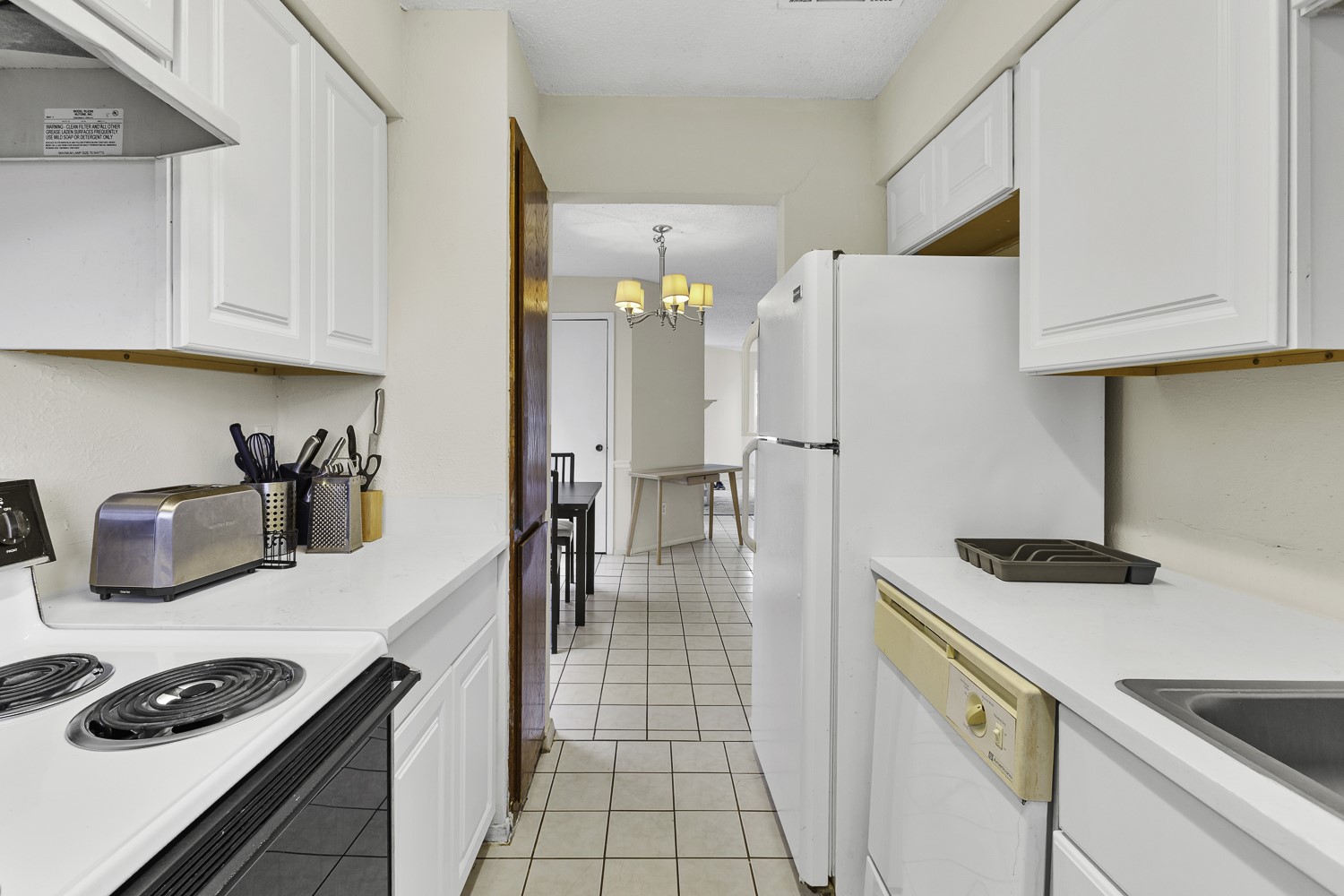 1907 West Loop Austin, TX 78758 - Photo 7 of 22 a kitchen with stainless steel appliances granite countertop a refrigerator and a stove