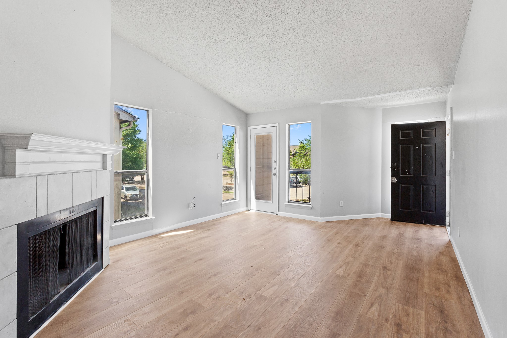 1907 West Loop Austin, TX 78758 - Photo 8 of 31 an empty room with windows and fireplace