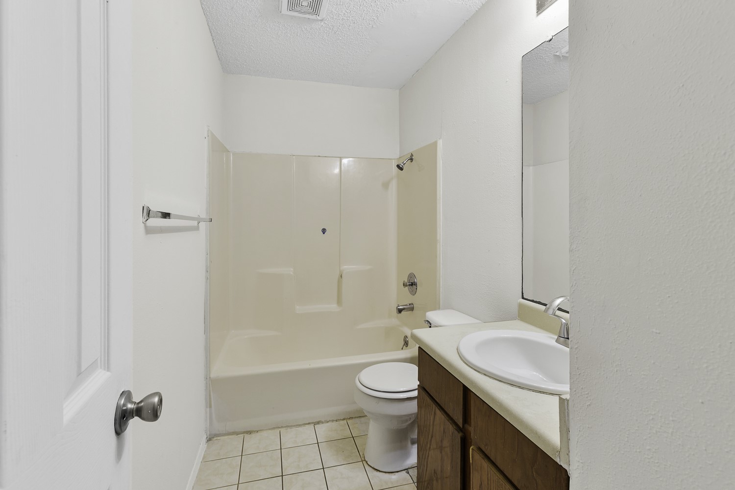 1907 West Loop Austin, TX 78758 - Photo 8 of 22 a bathroom with a granite countertop sink a toilet and shower