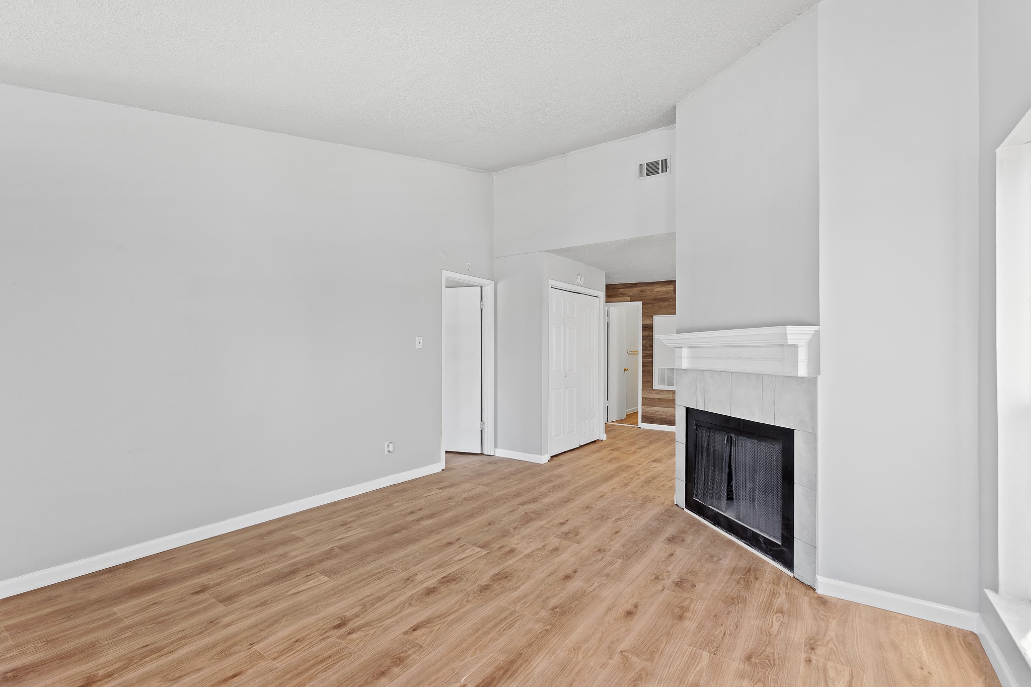 1907 West Loop Austin, TX 78758 - Photo 9 of 31 a view of empty room with wooden floor and fireplace