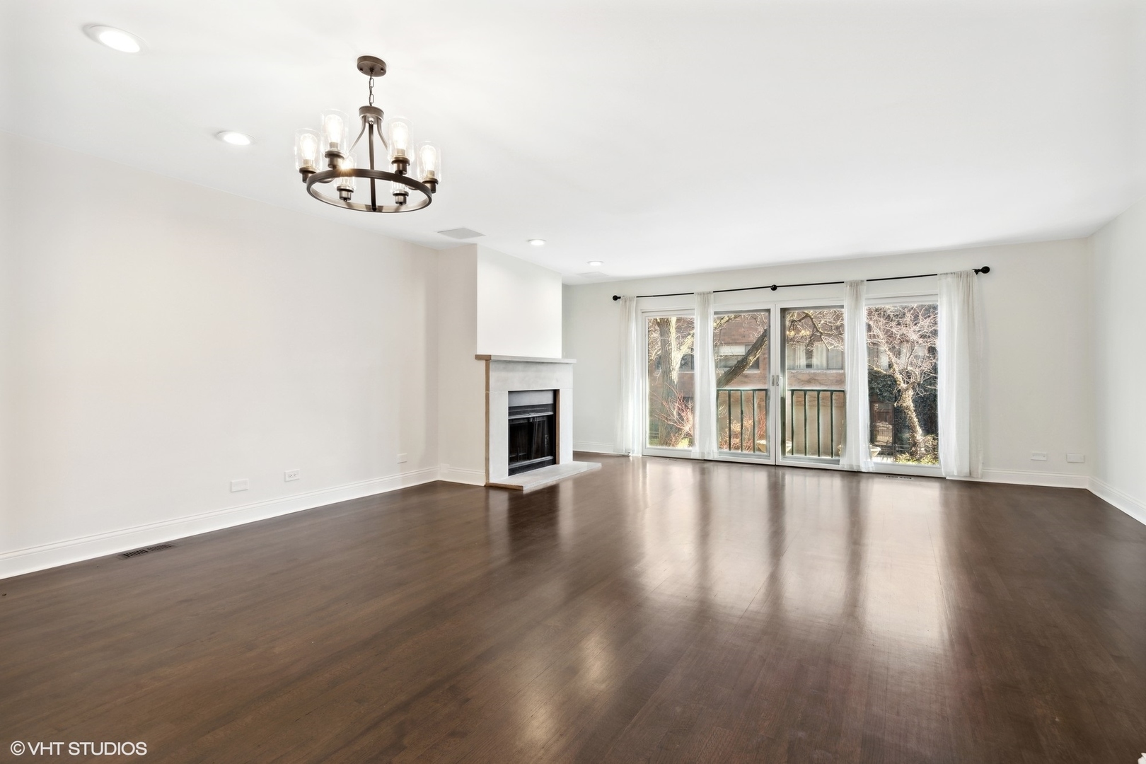 641 West Willow Street, Unit 117 Chicago, IL 60614 - Photo 25 of 44 an empty room with wooden floor chandelier and windows