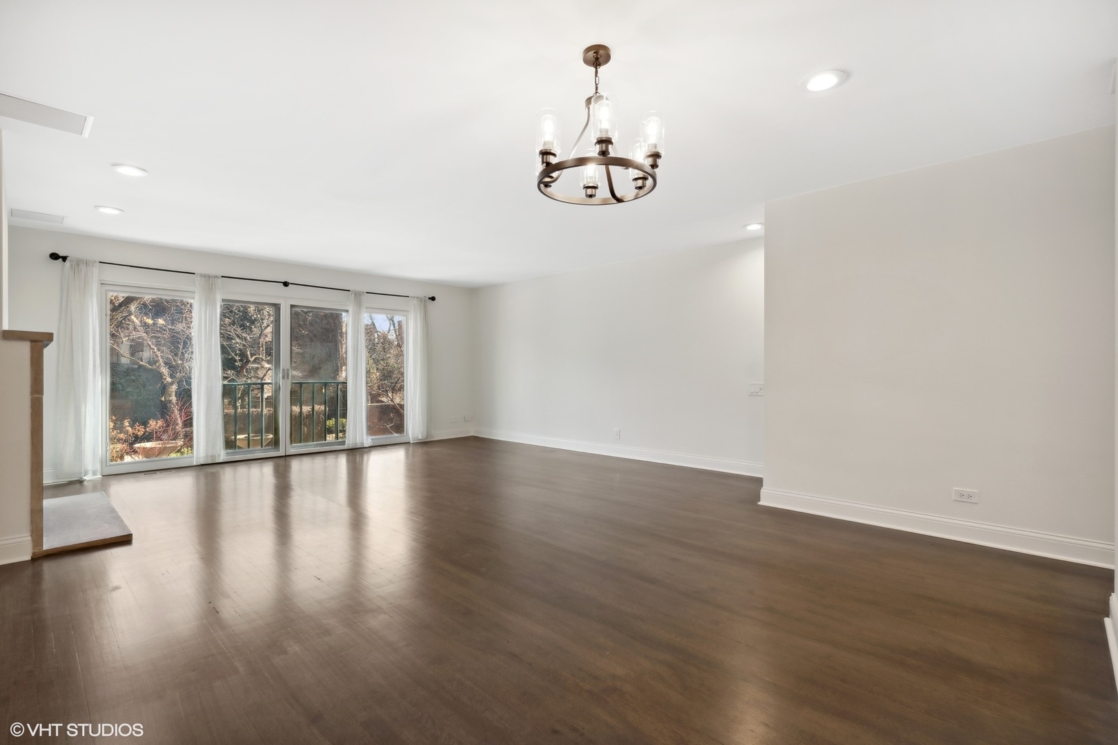 641 West Willow Street, Unit 117 Chicago, IL 60614 - Photo 26 of 44 a view of an empty room with wooden floor and windows