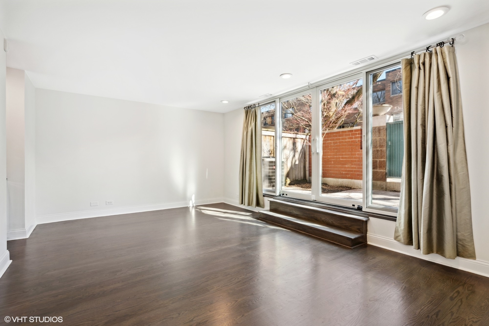 641 West Willow Street, Unit 117 Chicago, IL 60614 - Photo 27 of 44 an empty room with wooden floor and windows