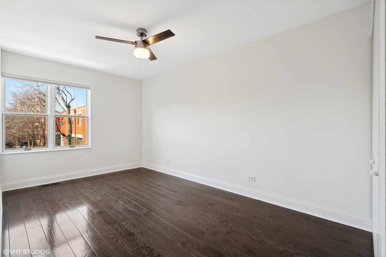 641 West Willow Street, Unit 117 Chicago, IL 60614 - Photo 35 of 44 an empty room with wooden floor fan and windows