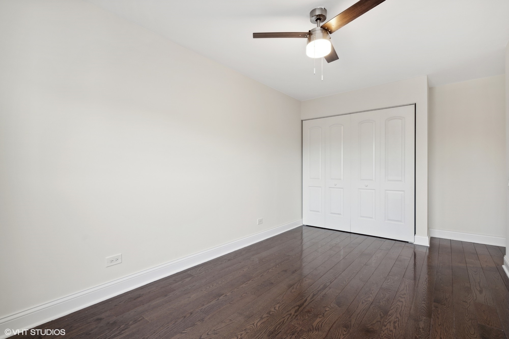 641 West Willow Street, Unit 117 Chicago, IL 60614 - Photo 36 of 44 an empty room with wooden floor and fan