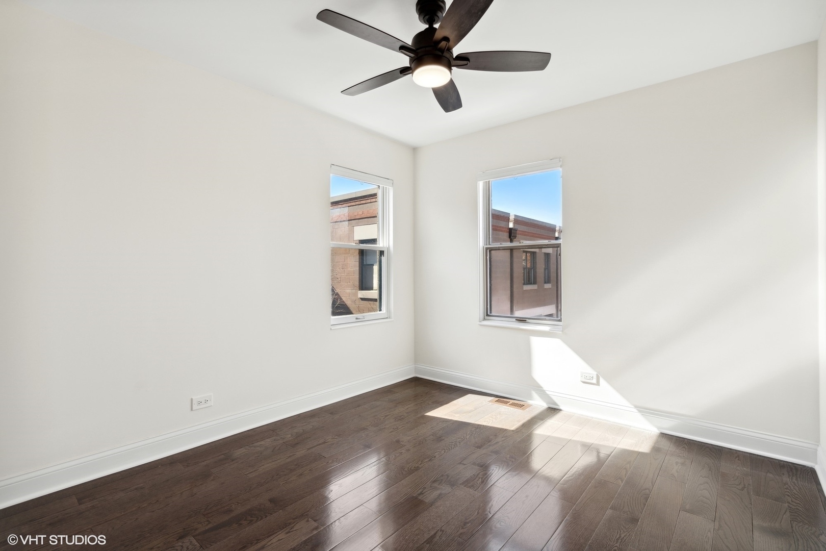 641 West Willow Street, Unit 117 Chicago, IL 60614 - Photo 37 of 44 an empty room with wooden floor chandelier fan and windows