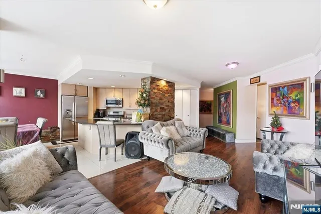 a living room with furniture and a dining table with wooden floor