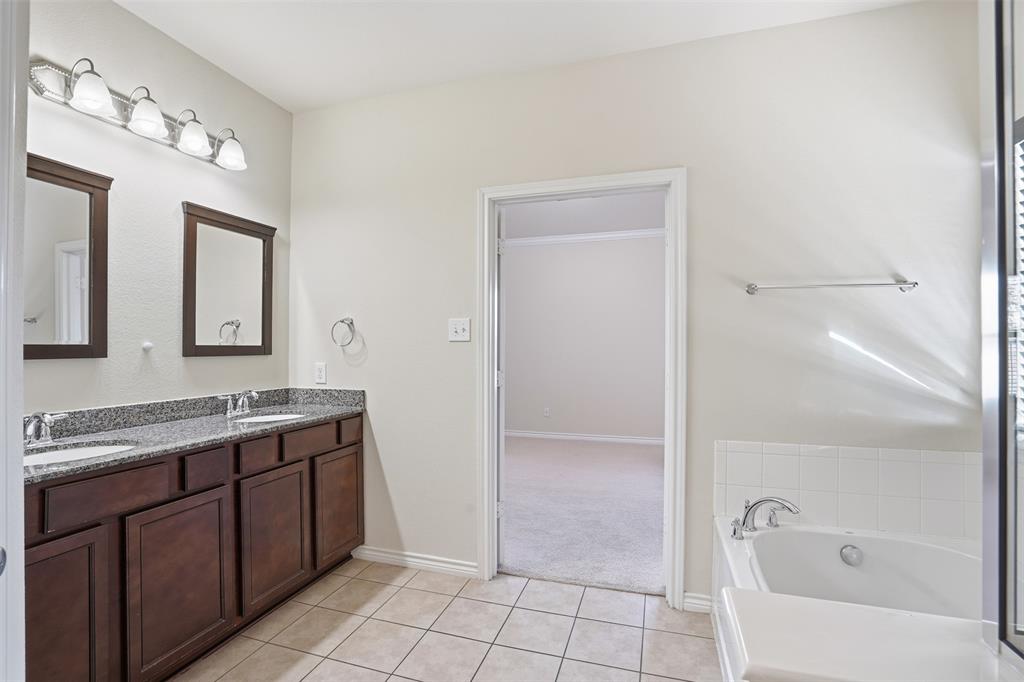 3913 Weatherstone Drive Fort Worth, TX 76137 - Photo 12 of 20 a spacious bathroom with a tub sink and mirror