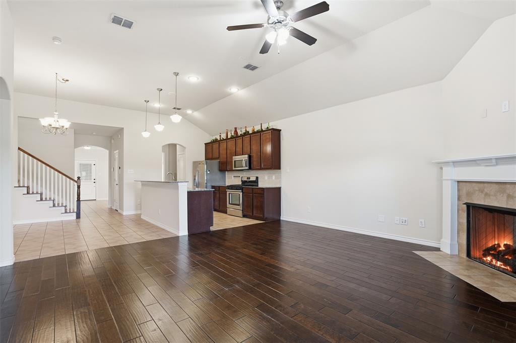 3913 Weatherstone Drive Fort Worth, TX 76137 - Photo 8 of 20 a view of a room with wooden floor and a kitchen