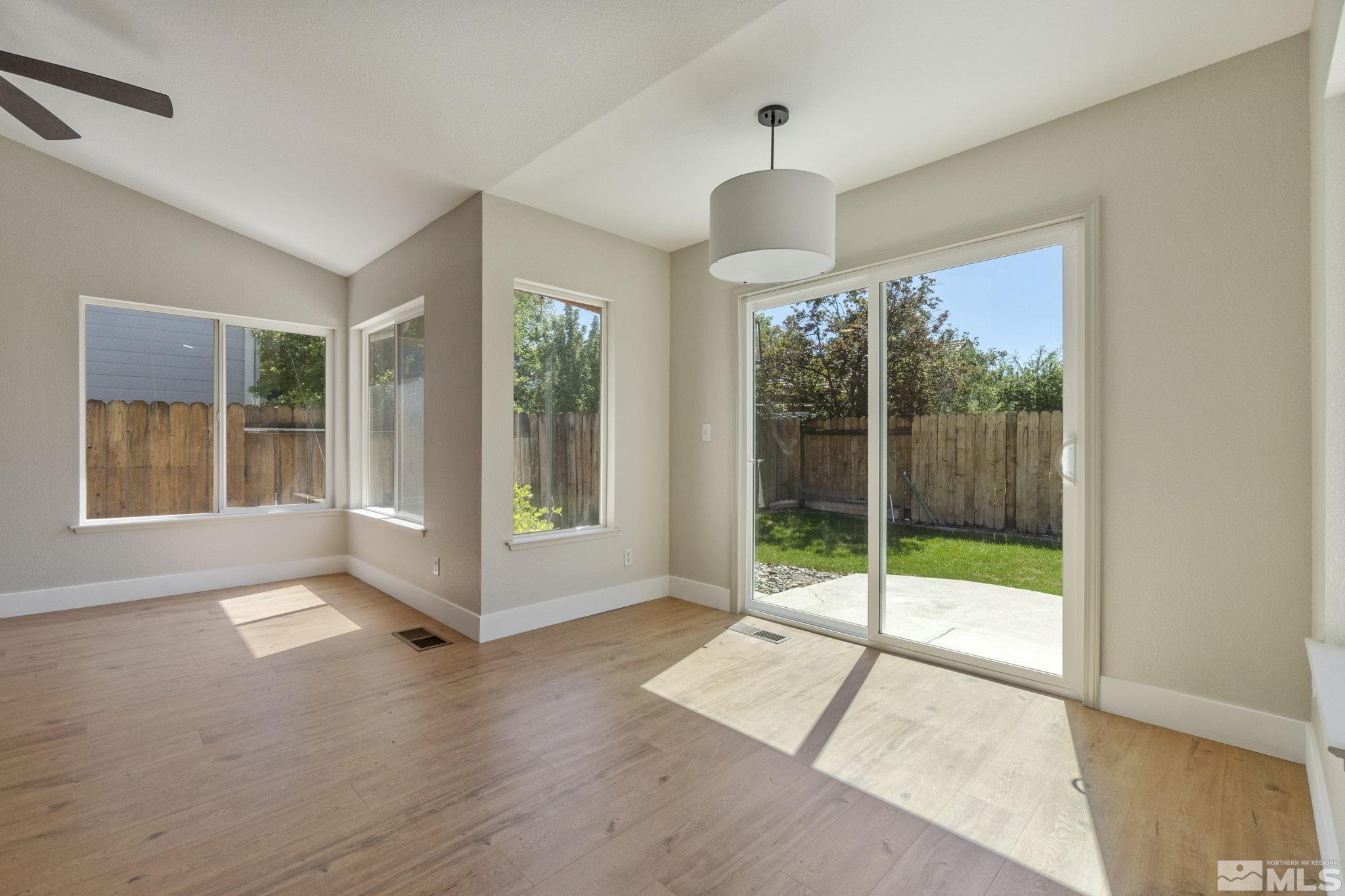 9721 Northmont Lane Reno, NV 89521 - Photo 11 of 40 a view of an empty room with glass door and windows