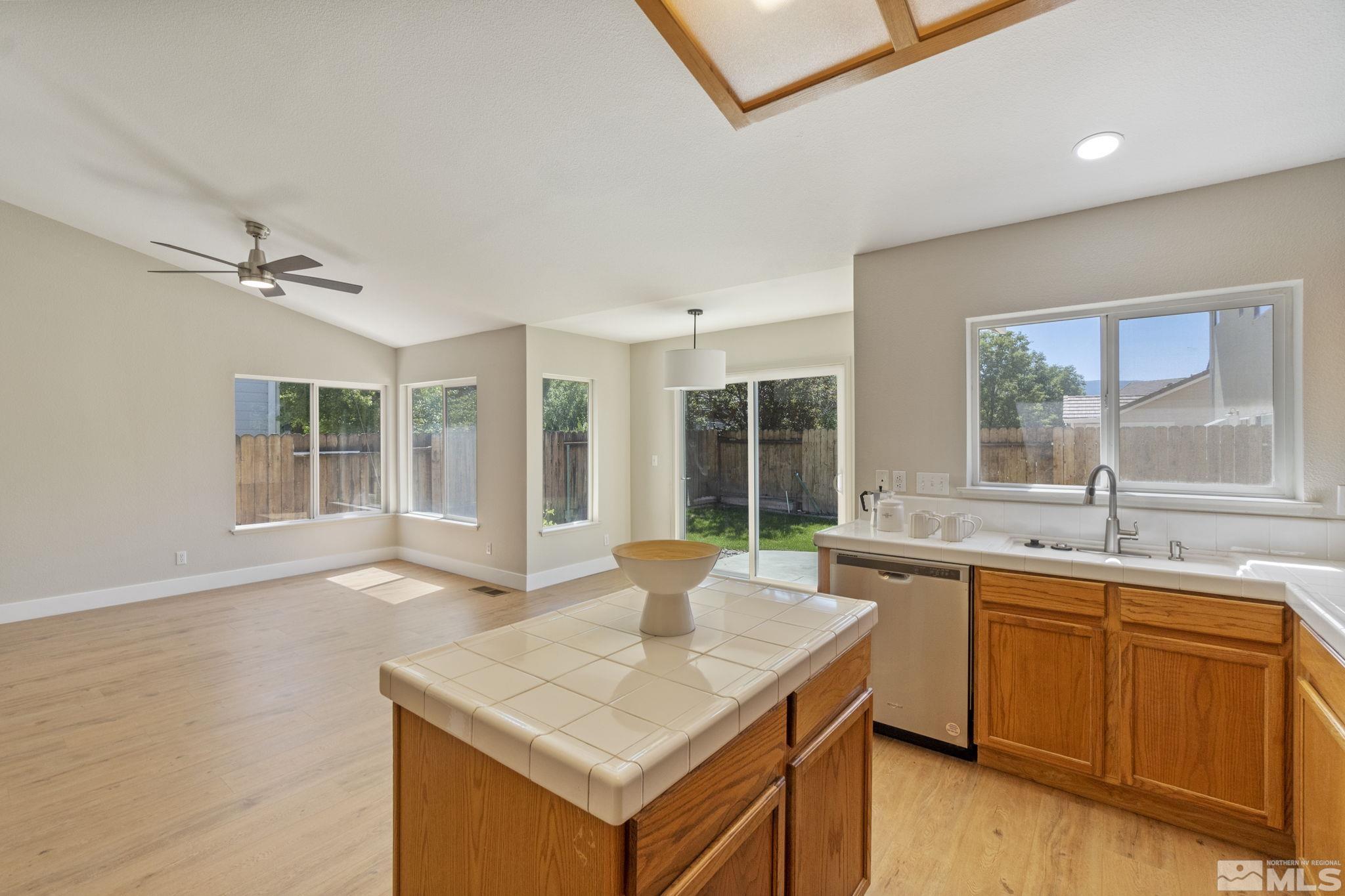 9721 Northmont Lane Reno, NV 89521 - Photo 15 of 40 a kitchen with a sink stove and cabinets