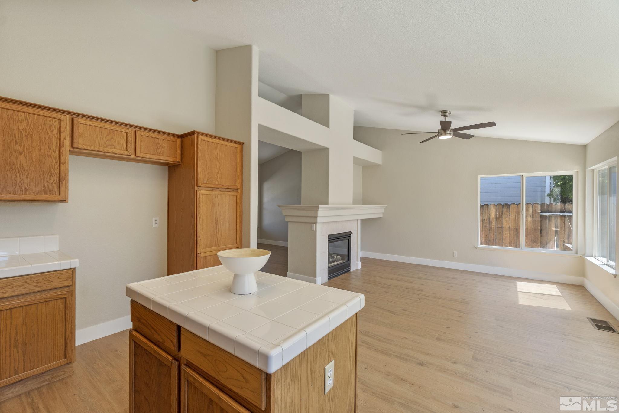 9721 Northmont Lane Reno, NV 89521 - Photo 17 of 40 a view of a kitchen with cabinets and wooden floor