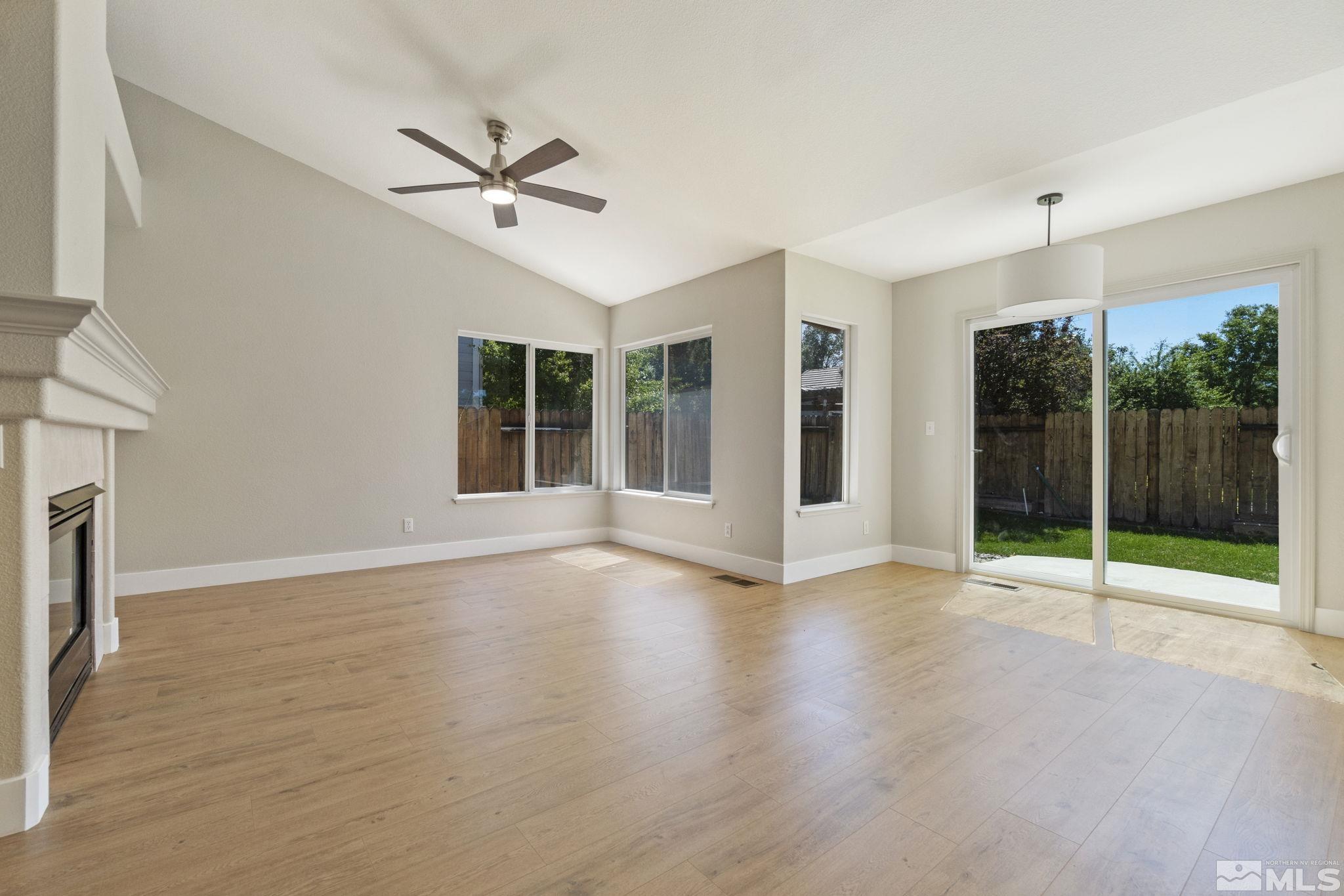 9721 Northmont Lane Reno, NV 89521 - Photo 2 of 40 a view of an empty room with glass door and a ceiling fan