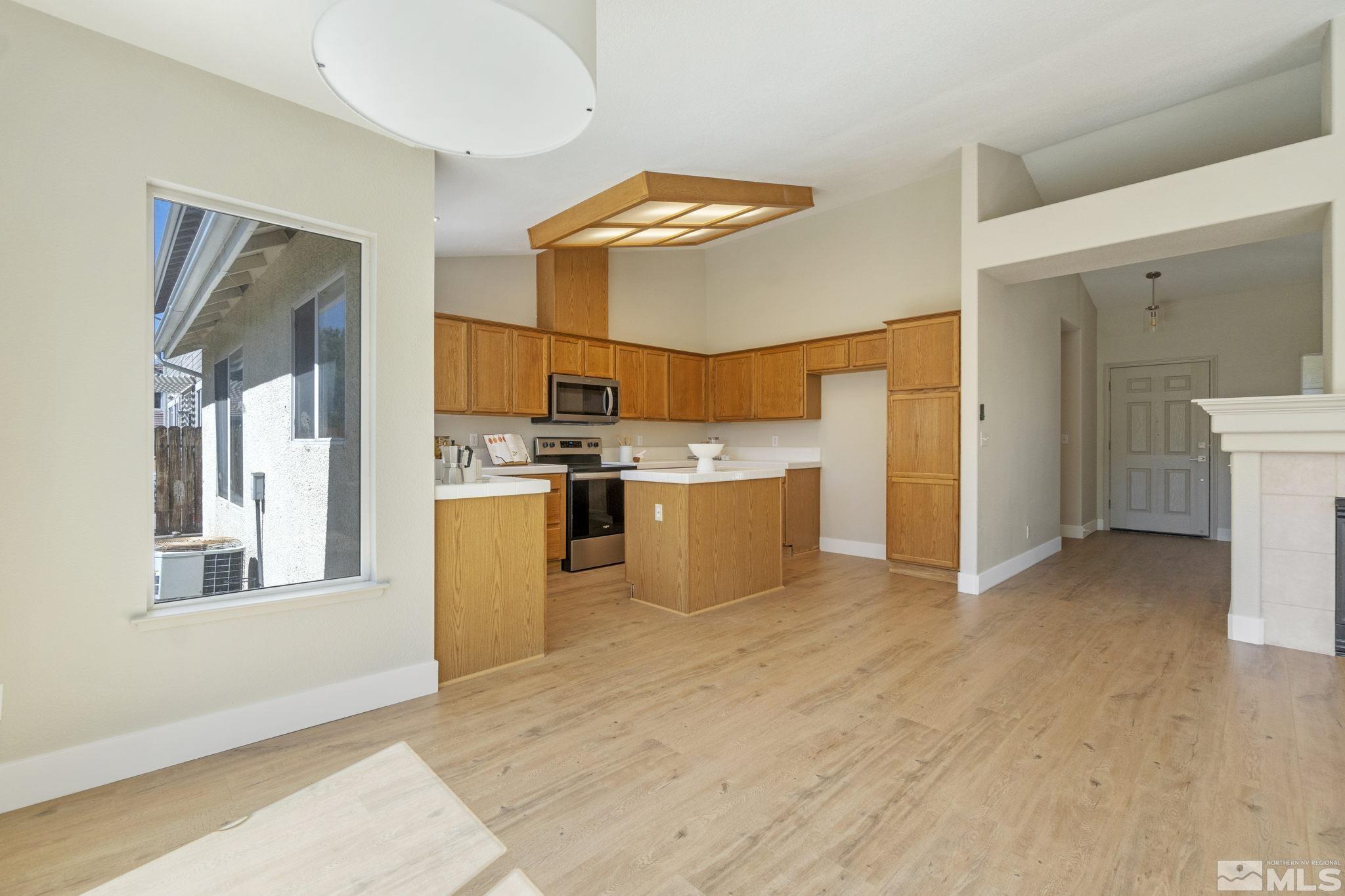 9721 Northmont Lane Reno, NV 89521 - Photo 21 of 40 a kitchen with stainless steel appliances a refrigerator and a stove