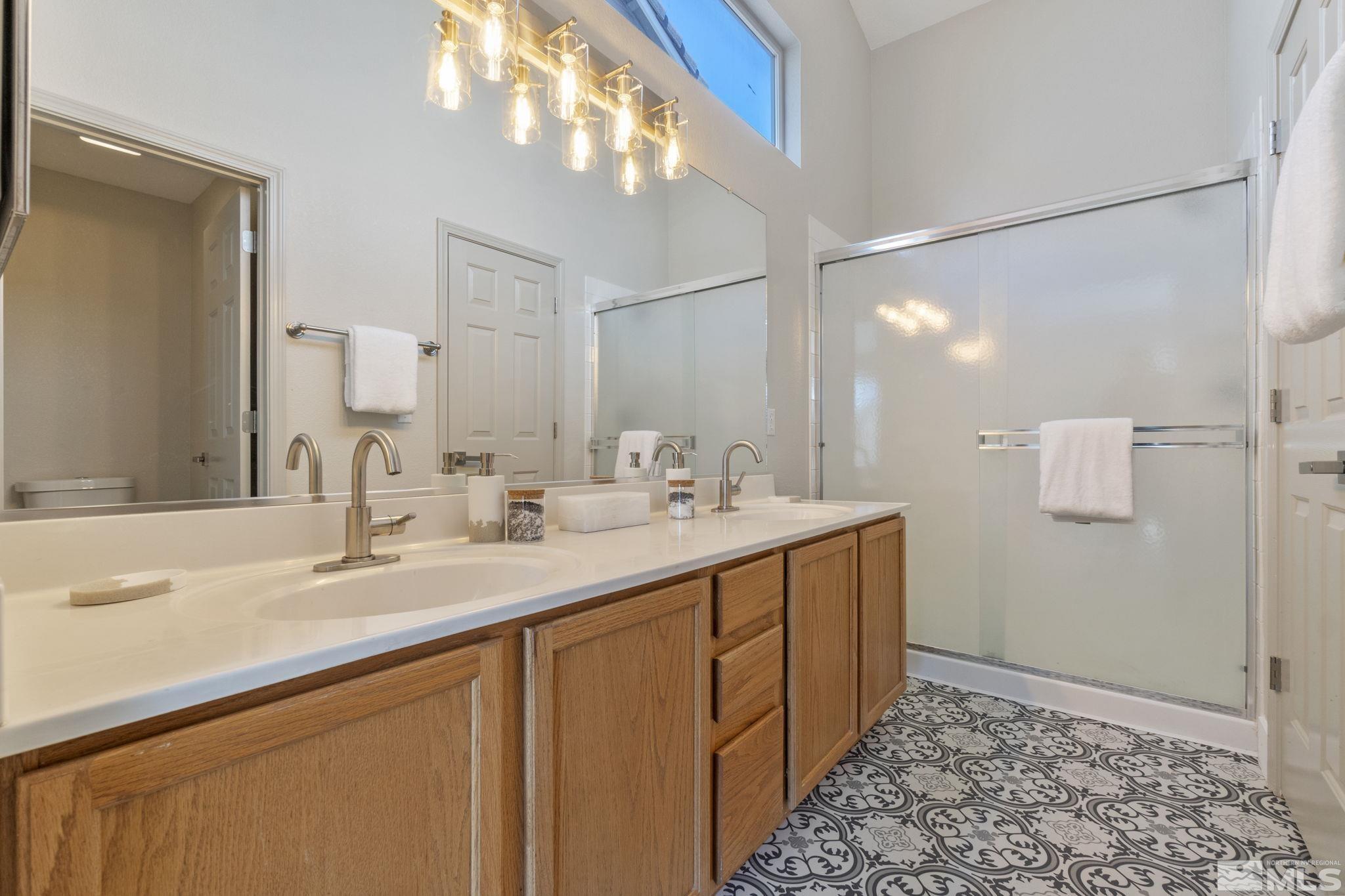 9721 Northmont Lane Reno, NV 89521 - Photo 24 of 40 a bathroom with a double vanity sink and a mirror