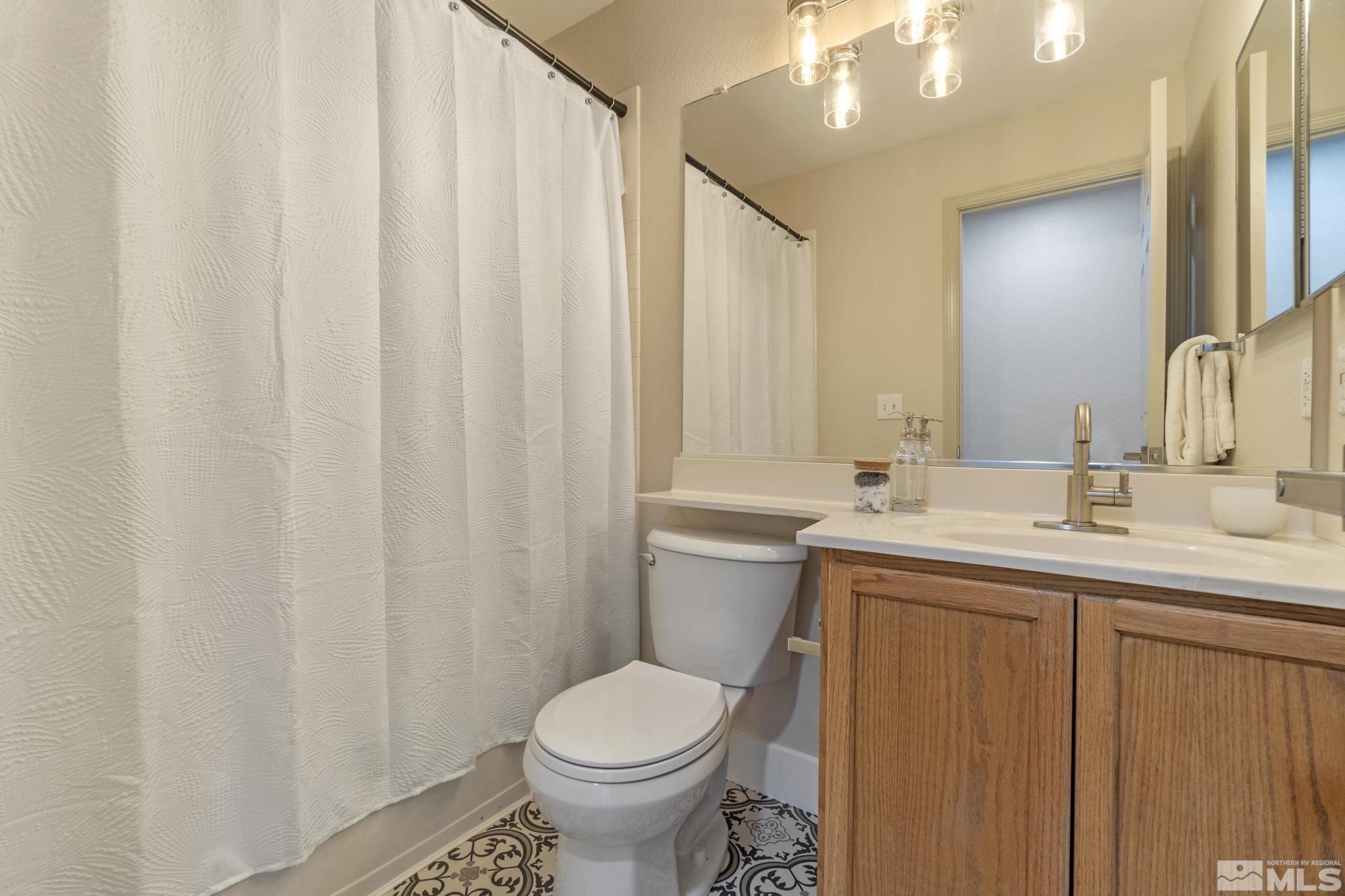 9721 Northmont Lane Reno, NV 89521 - Photo 26 of 40 a bathroom with a toilet sink and mirror