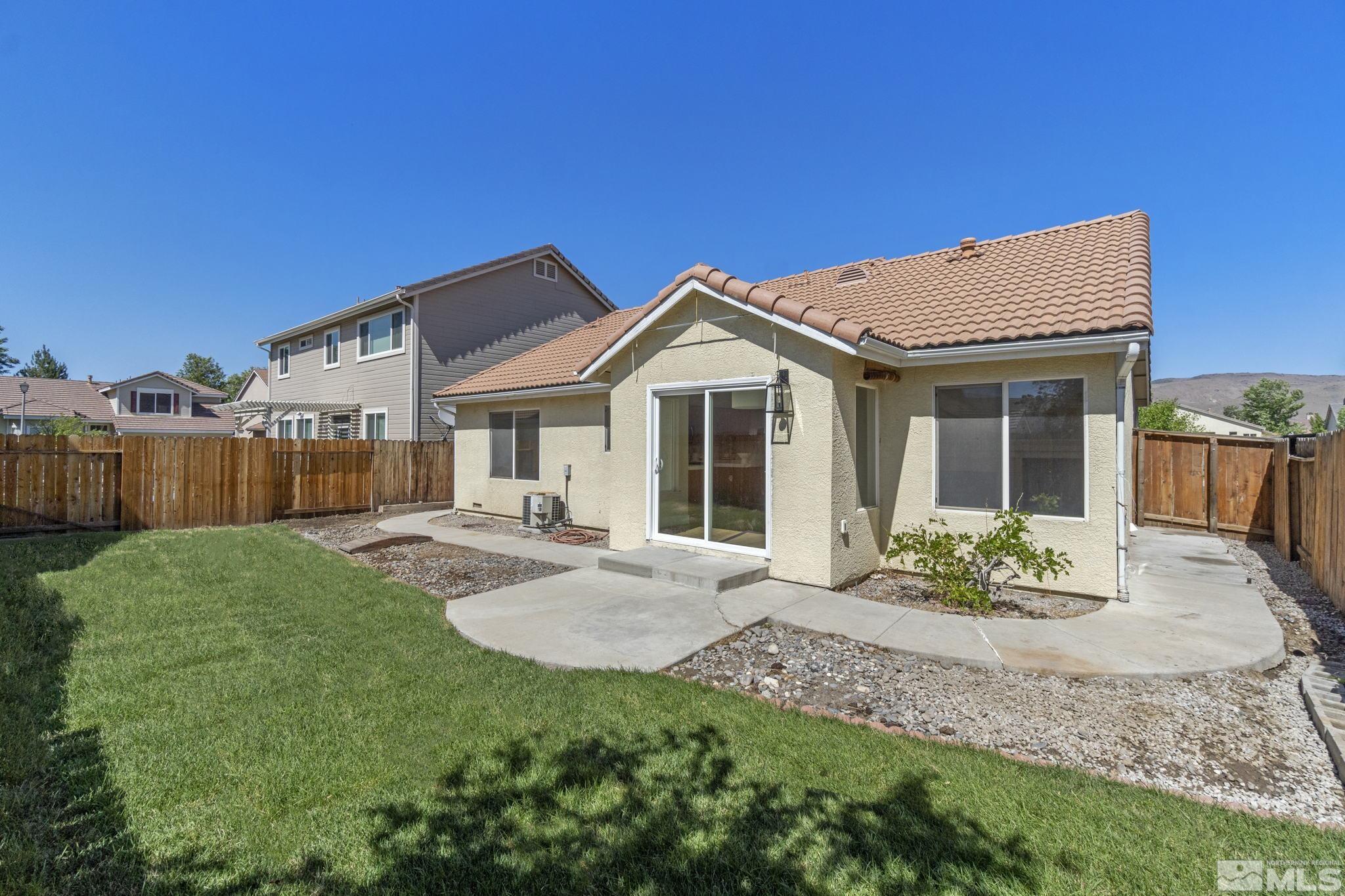 9721 Northmont Lane Reno, NV 89521 - Photo 29 of 40 a front view of a house with a garden and yard
